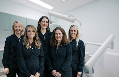 The five doctors of dental medicine smiling at Reich Dental Center – Roswell in Roswell, GA