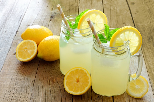 two mason jars full of fresh citrus juices